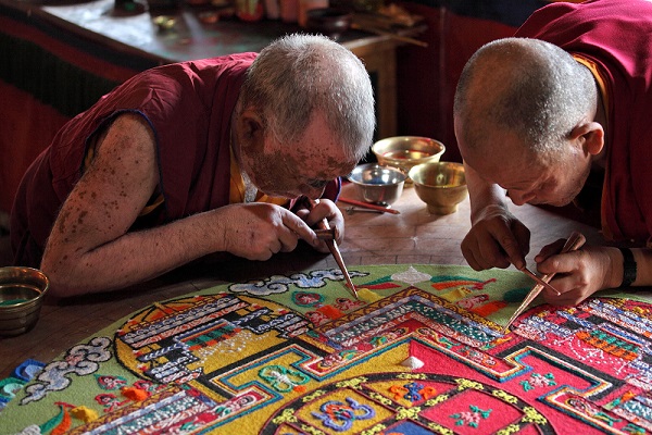 LADAKH, INDIA - SEPTEMBER 03, 2011: Buddhist monks making sand m