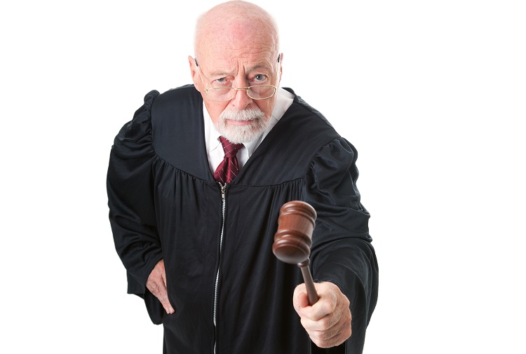 No nonsense, skeptical old judge banging his gavel.  Isolated on