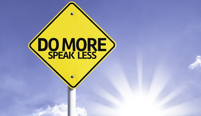 Do More, Speak Less road sign with sun background